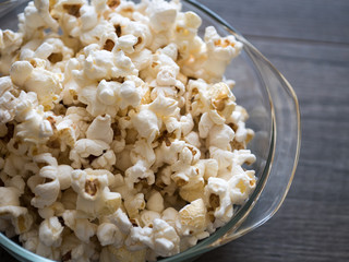 popcorn in a bowl on a wooden background