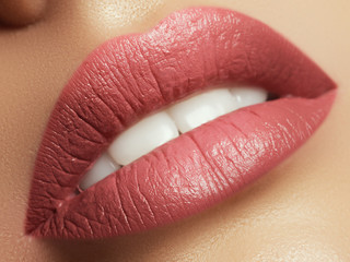 Close-up beautiful female lips with bright lipgloss makeup. Perfect clean skin, light fresh lip...