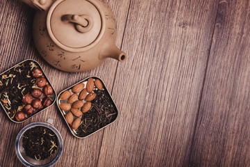 Tea strainer with tea on a wooden surface. Green and black tea Top view with copy space