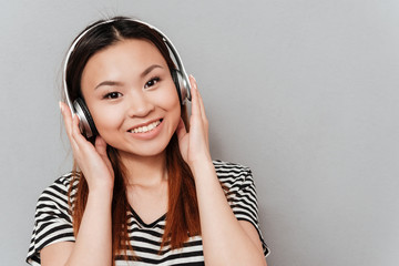 Happy young pretty woman listening music with headphones