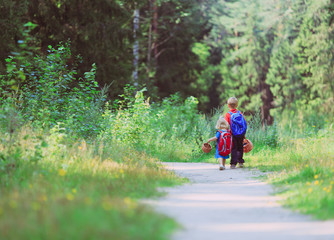 little boy and girl walking in forest