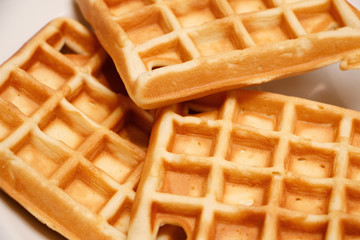 Freshly baked waffles on a white plate