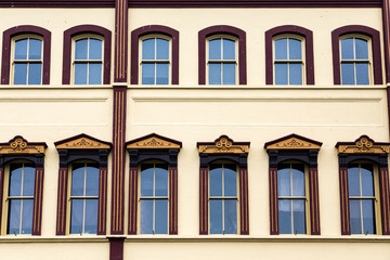 Fototapeta premium Ornate Windows on Yellow Plaster Building