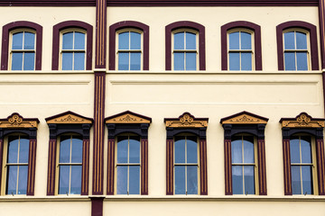 Ornate Windows on Yellow Plaster Building