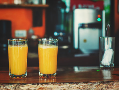 Morning scene of fresh orange juices served in bar