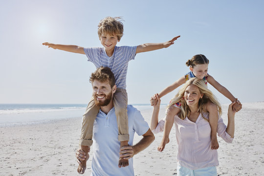 Happy family strolling on the beach