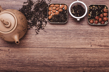 Tea strainer with tea on a wooden surface. Green and black tea Top view with copy space