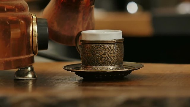 Coffee poured in a cup from the Turks