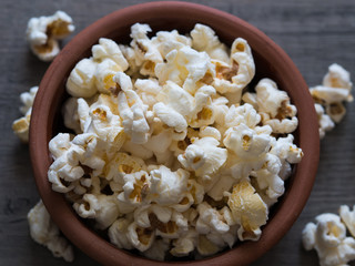 popcorn in a bowl on a wooden background