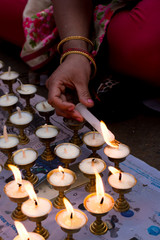 Nepali people lighting oil lamps on day of Vesak, Visaka, people praying for world peace and those who died on massive earthquake on 25 april 2015 in Nepal