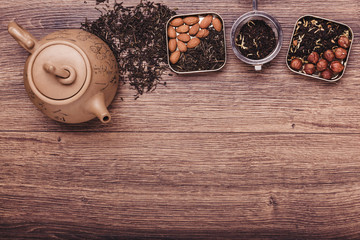 Tea strainer with tea on a wooden surface. Green and black tea Top view with copy space
