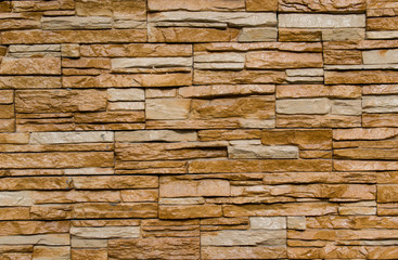 The background of the wall surface of the treated stones, covered with light brown varnish
