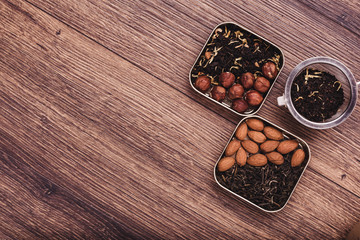 Tea strainer with tea on a wooden surface. Green and black tea Top view with copy space