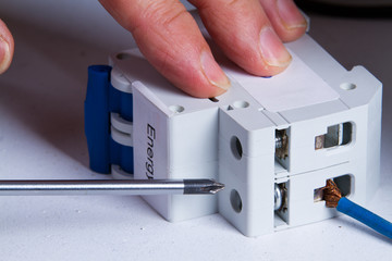 electrician fixing electrical device