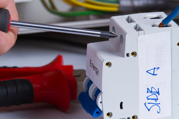 electrician fixing electrical device