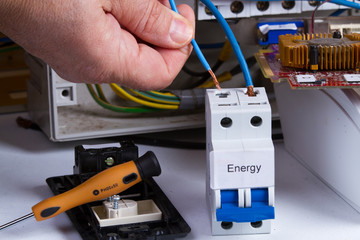 electrician fixing electrical device