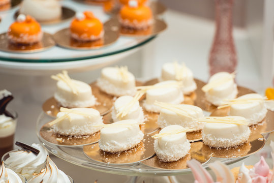 glass stand with cupcakes on a wedding candy bar table