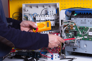 electrician fixing electrical device