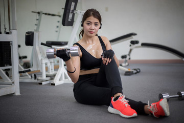 Fototapeta na wymiar beautiful muscular fit woman exercising building muscles and fitness woman doing exercises in the gym. Fitness - concept of healthy lifestyle,soft focus