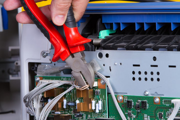 electrician fixing electrical device