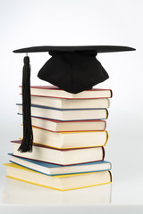 mortarboard on books stack