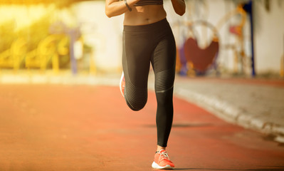 Running woman. Female runner jogging during outdoor  on road .Young mixed race girl jogging