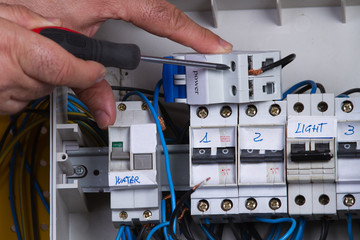 electrician fixing electrical device