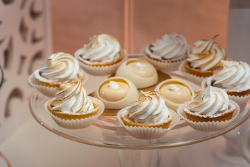 glass stand with cupcakes on a wedding candy bar table