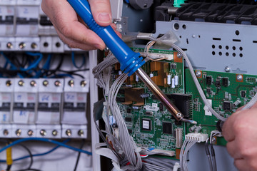 electrician fixing electrical device