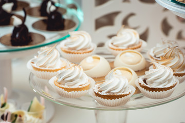 glass stand with cupcakes on a wedding candy bar table