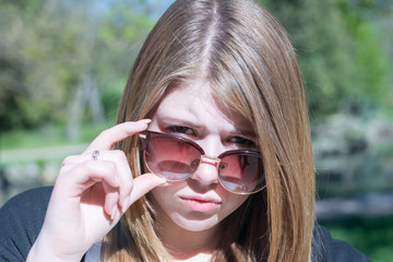 Serious girl look in sunglasses