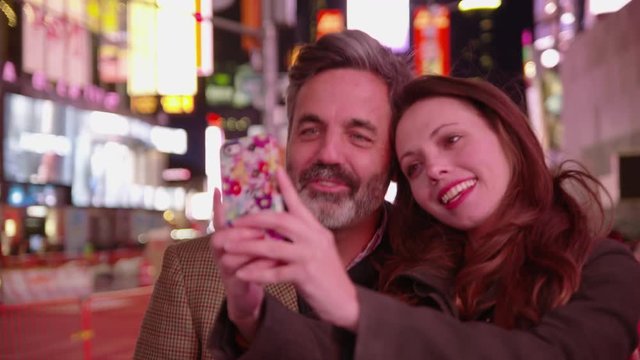 Couple taking selfie in Times Square, New York City