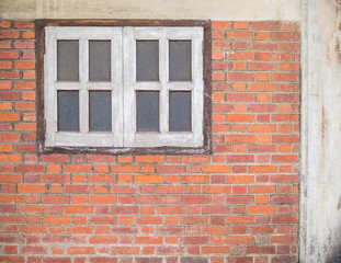 Fototapeta na wymiar Old brickwall and the window