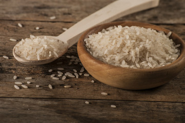 a bowl of rice on wooden surface