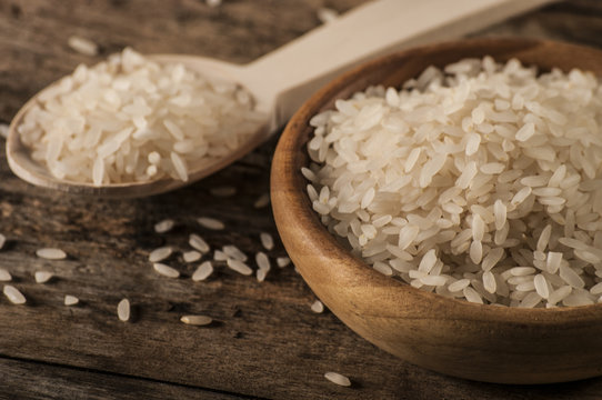 a bowl of rice on wooden surface