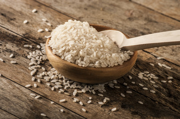 a bowl of rice on wooden surface