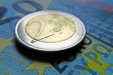 Euro money - 2 Euro coin on a banknote, detail