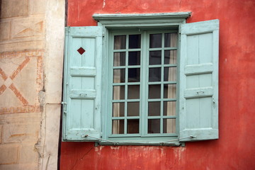 finestra azzurra su muro arancione