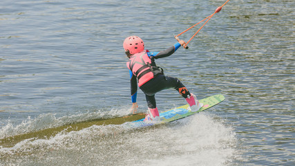 a little girl to ride a Wakeboard. Photo of grain processing