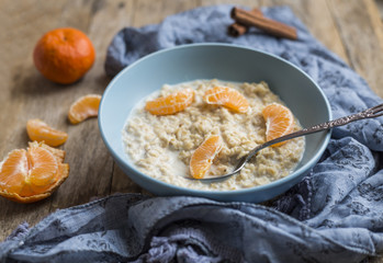 Healthy breakfast - oatmeal with slices of tangerines