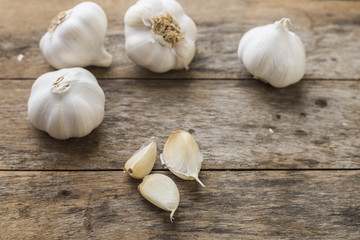 Garlic cloves on wooden vintage background.