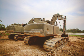 Excavator or backhoe at the construction site with Pale sky