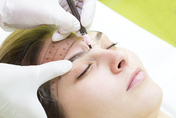 Naklejka premium Mikrobleyding eyebrows workflow in a beauty salon 