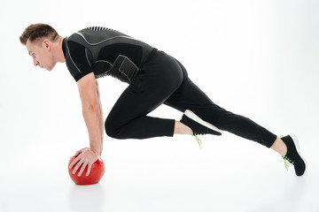 Obraz premium Side view full length portrait of a young muscular sportsman