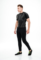 Full length of a healthy sportsman posing and looking away