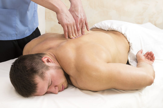 Young man on wellness treatments sports massage 