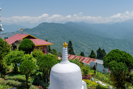 White stupa in Zang Dhok Palri Phodang  a Buddhist monastery in Kalimpong in West Bengal, India. and blue sky with clouds in the background .