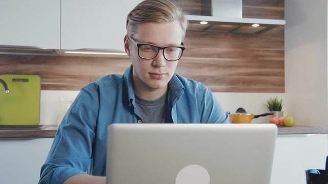 Young man using laptop computer at home