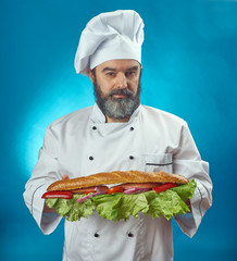  chief cook holding big sandwich