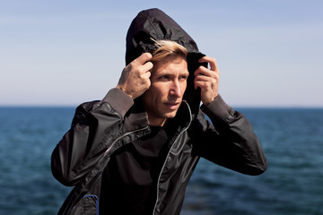 Confident man adjusting hood